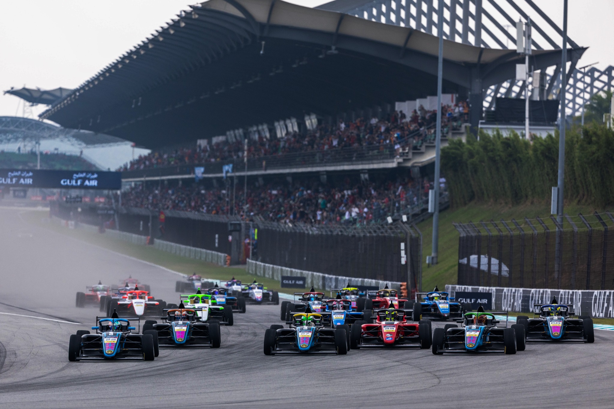 The Formula Trophy Malaysia field races past the Sepang grandstand
