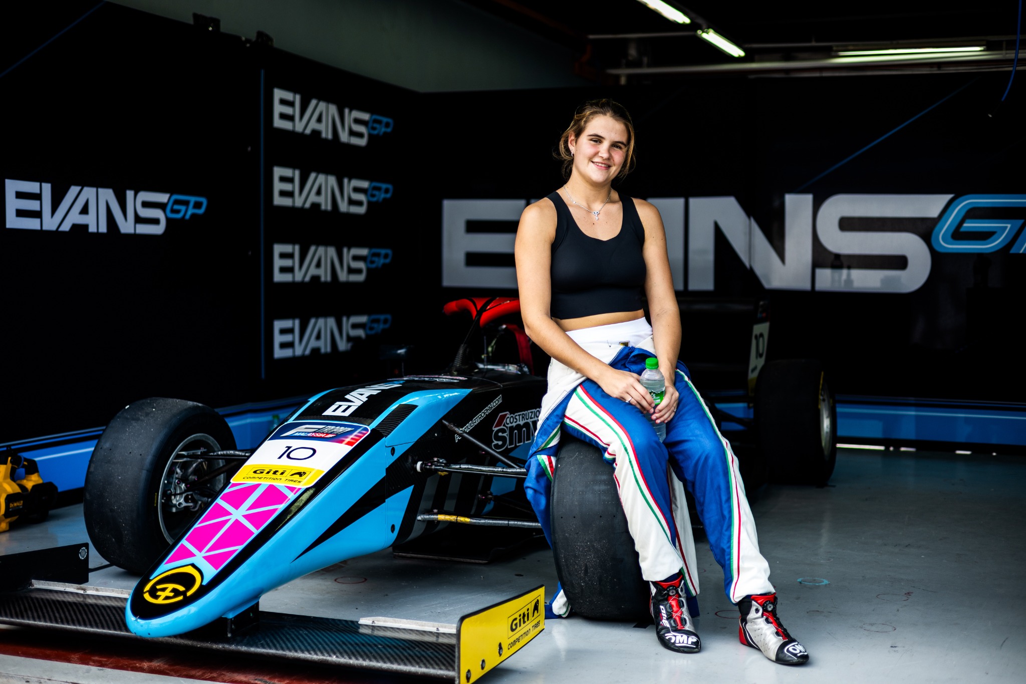 Kareen Kaur with an Evans GP Formula 4 car at Sepang